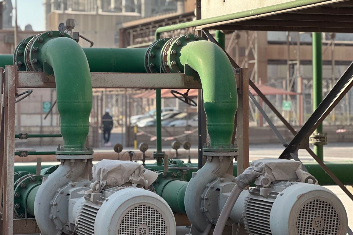 Pumps and green process piping inside a pump station