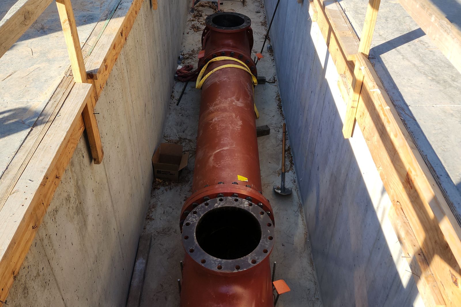 Large flanged pipe and tee inside the concrete structure of a water pump station in Bartow County, Georgia