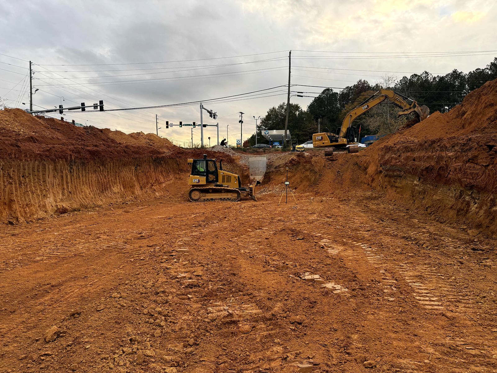Dozer and excavator on mass excavation near a signalized intersection at Twigs Farmers Market