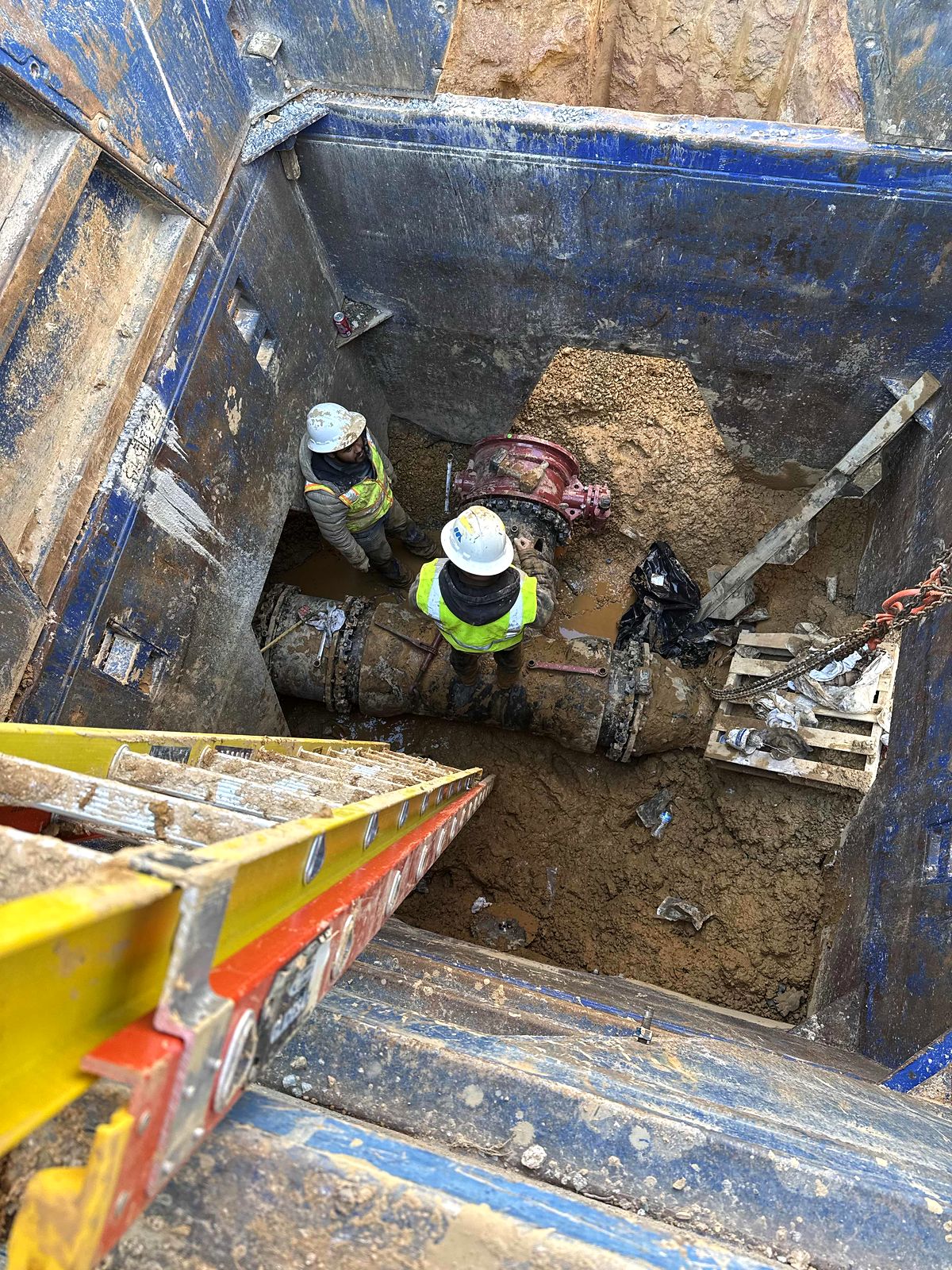 Crew connecting a valve on a large water line inside a trench box in Bartow County, Georgia