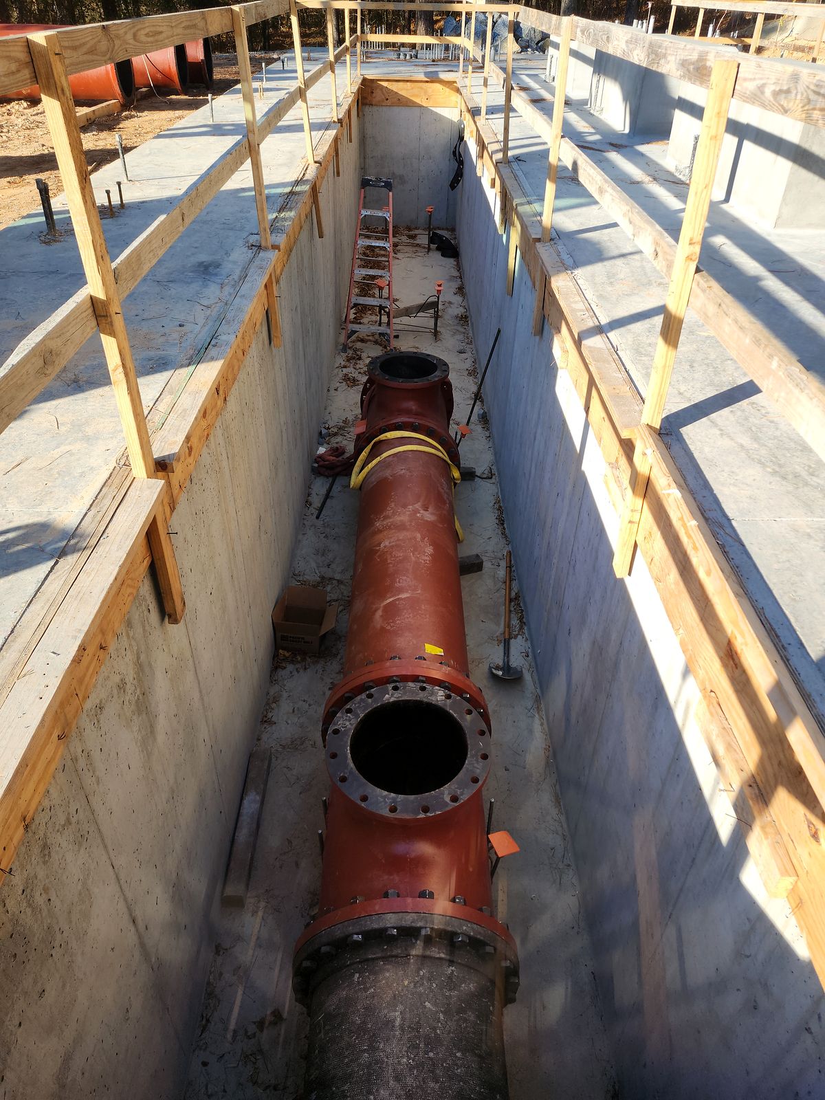 Large flanged pipe and tee inside the concrete pump station structure in Bartow County, Georgia