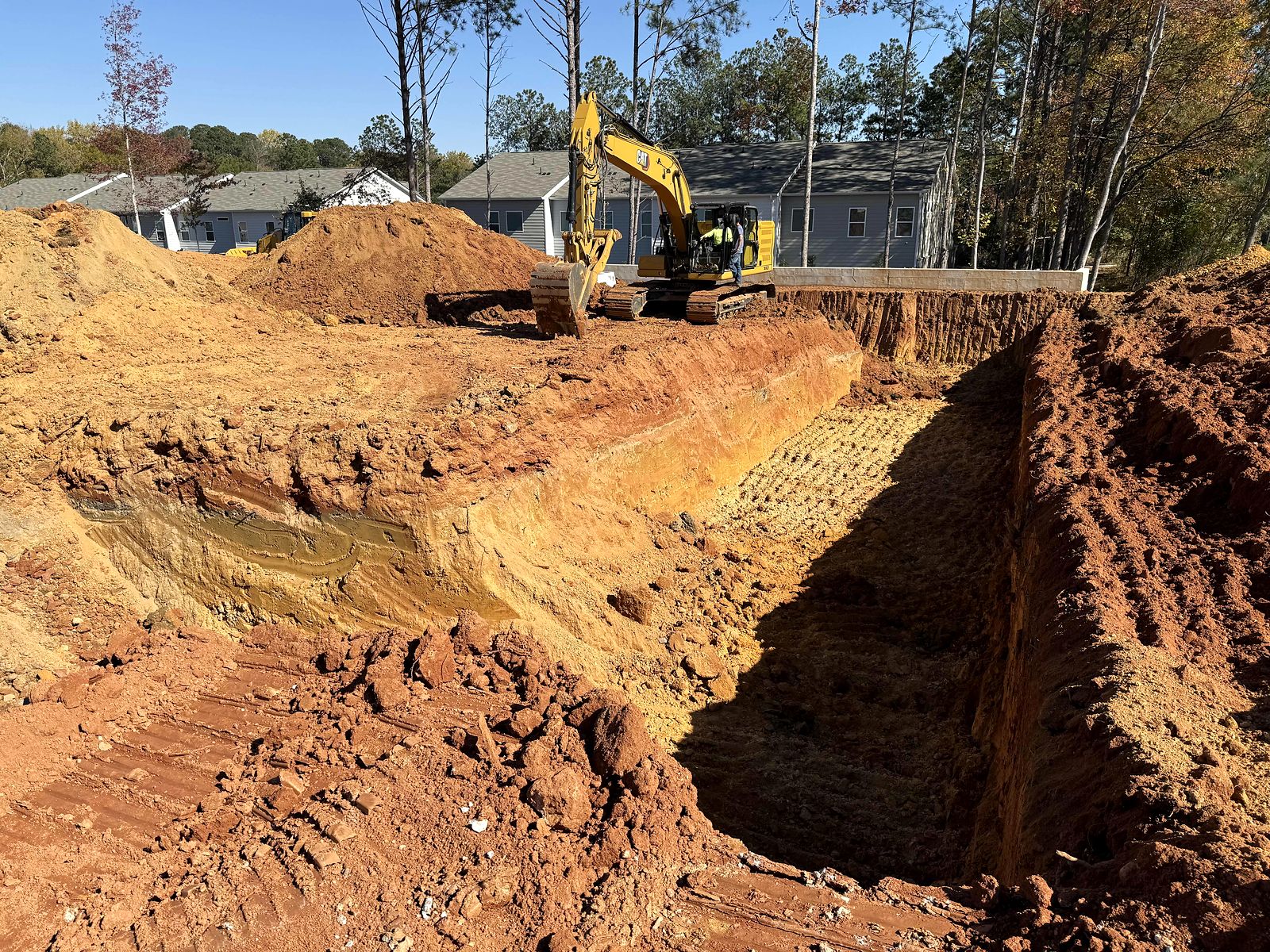 Excavator and deep excavation at the Twigs Farmers Market site