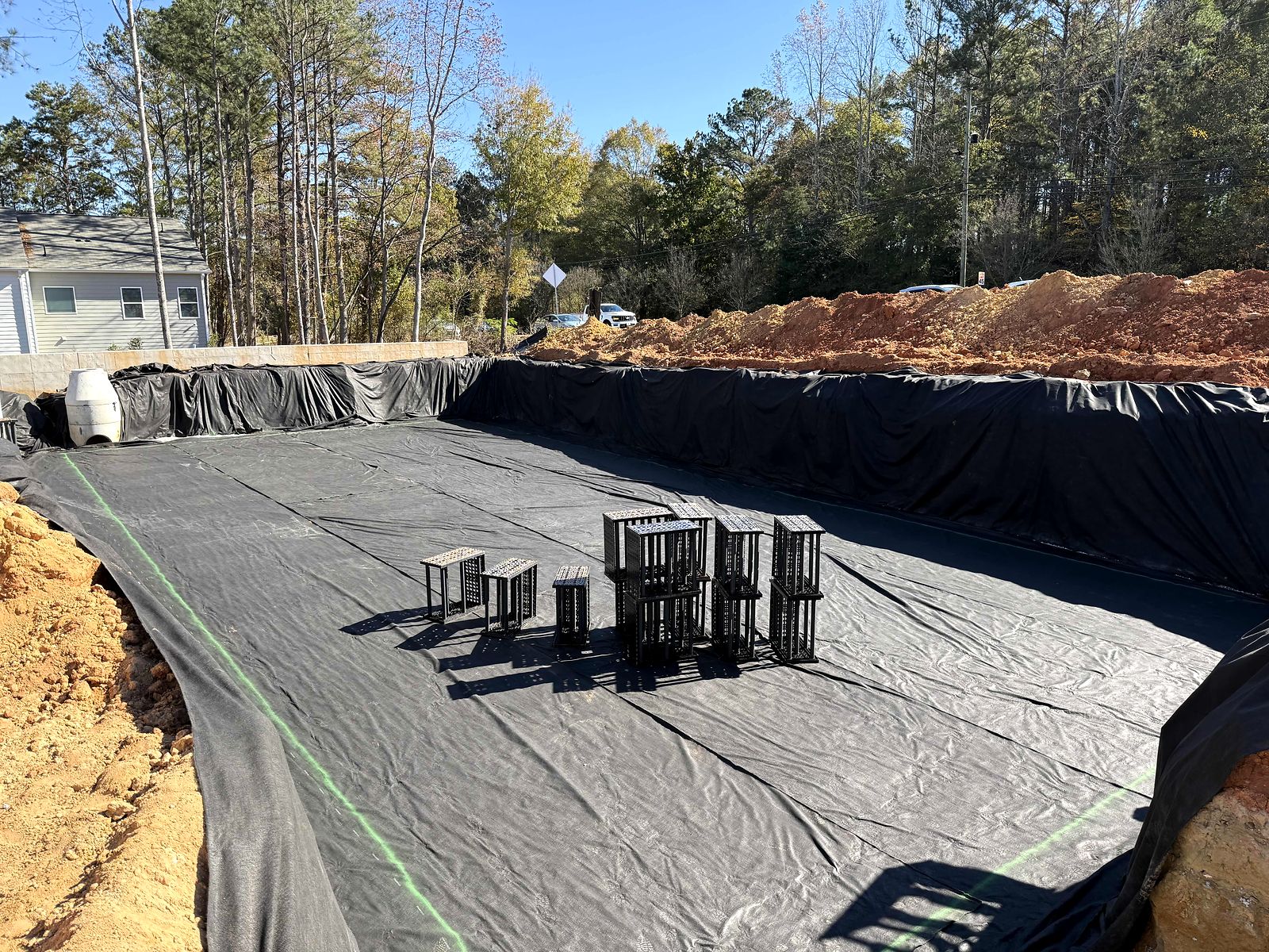 Liner and the first stacked storage modules on the gravel base at Twigs Farmers Market
