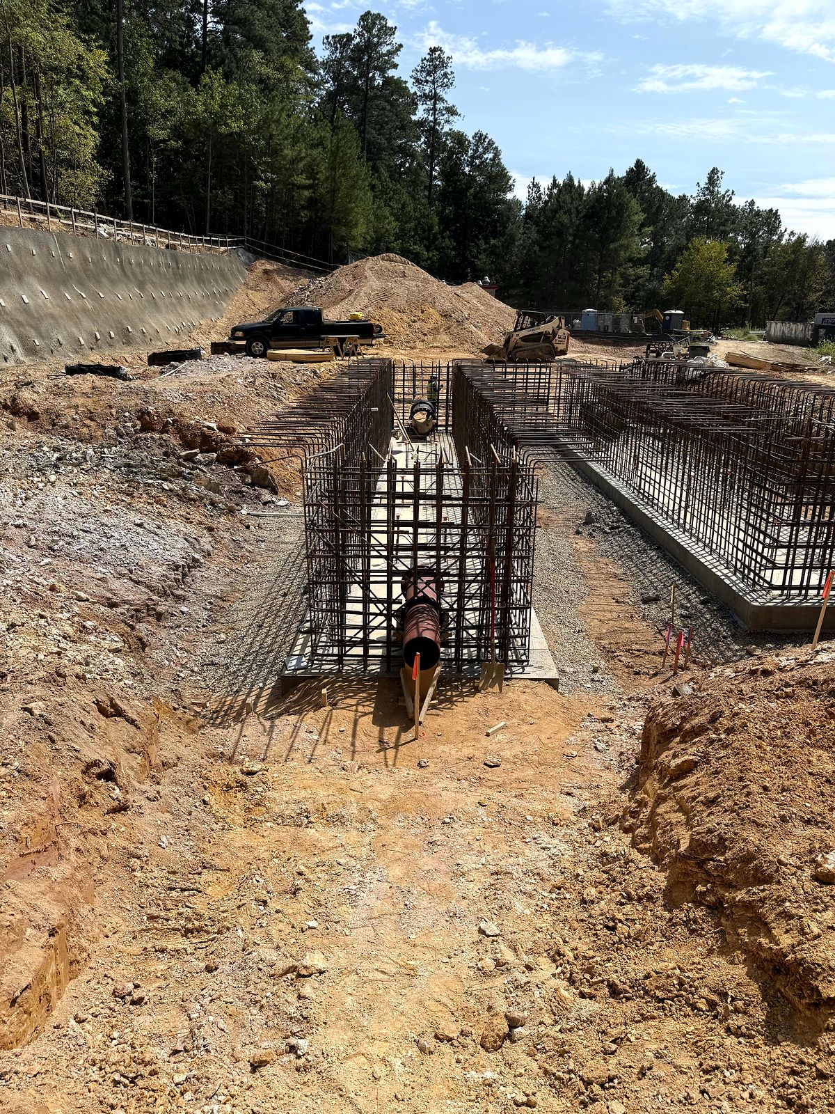 Rebar cages and forms for the concrete pump station structure, with large pipe set in place, in Bartow County, Georgia