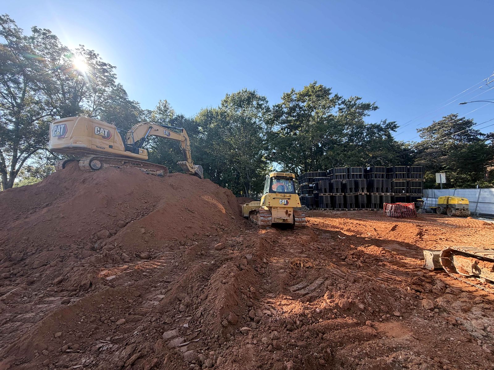 Excavator and dozer working beside stacked underground stormwater modules in Alpharetta, Georgia