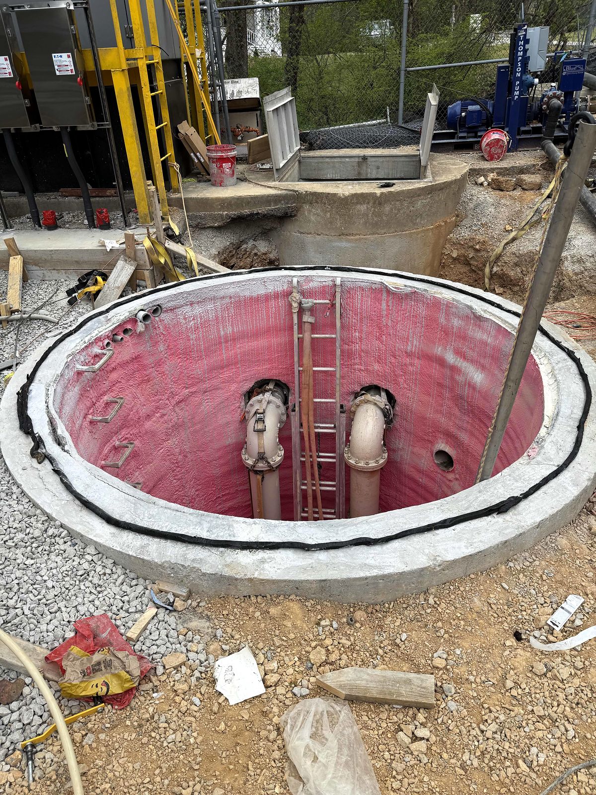 Open precast wet well with a lined interior, discharge pipes, and an access ladder in Blue Ridge, Georgia