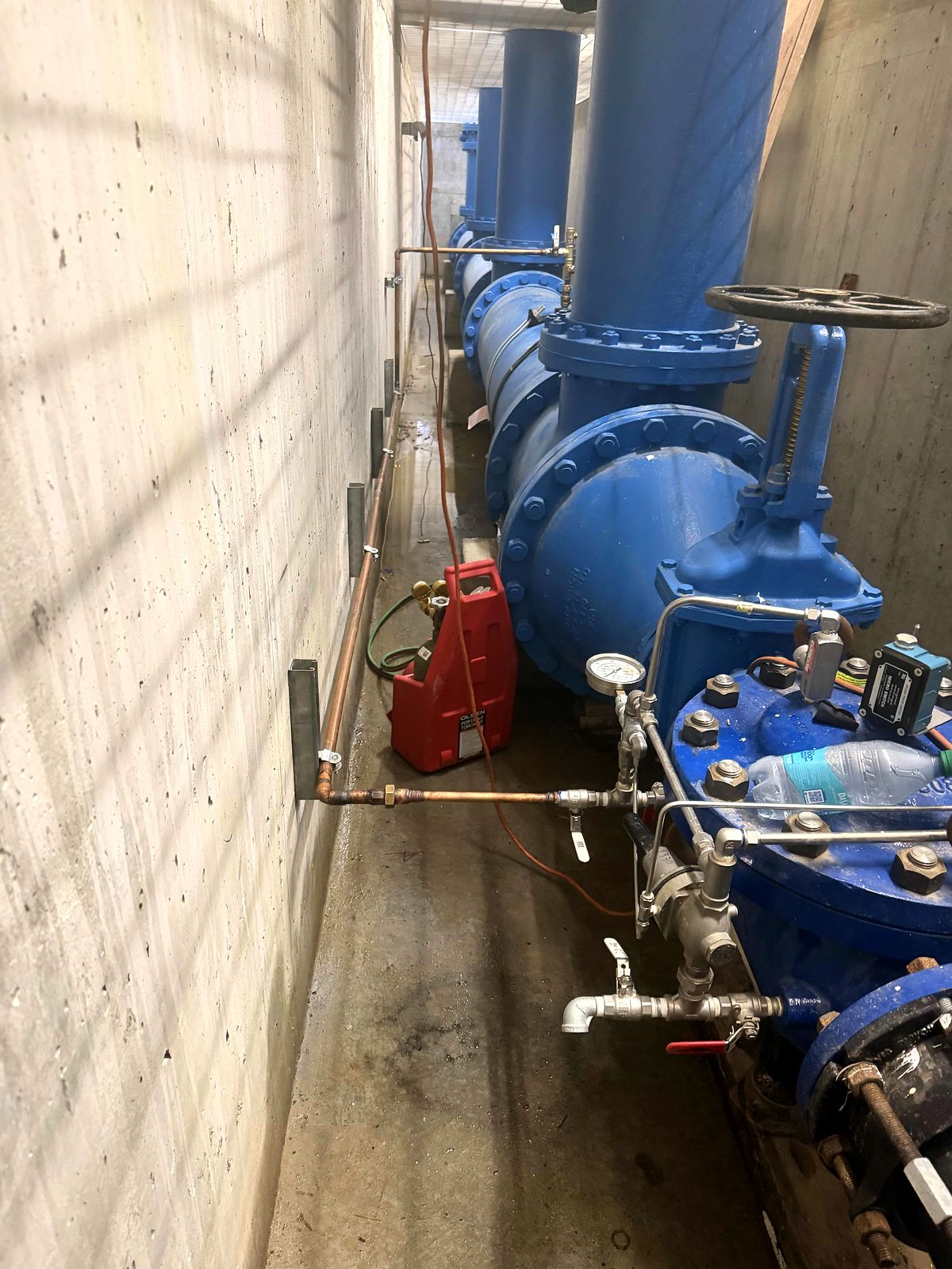 Blue valves and station piping inside the pump station in Bartow County, Georgia