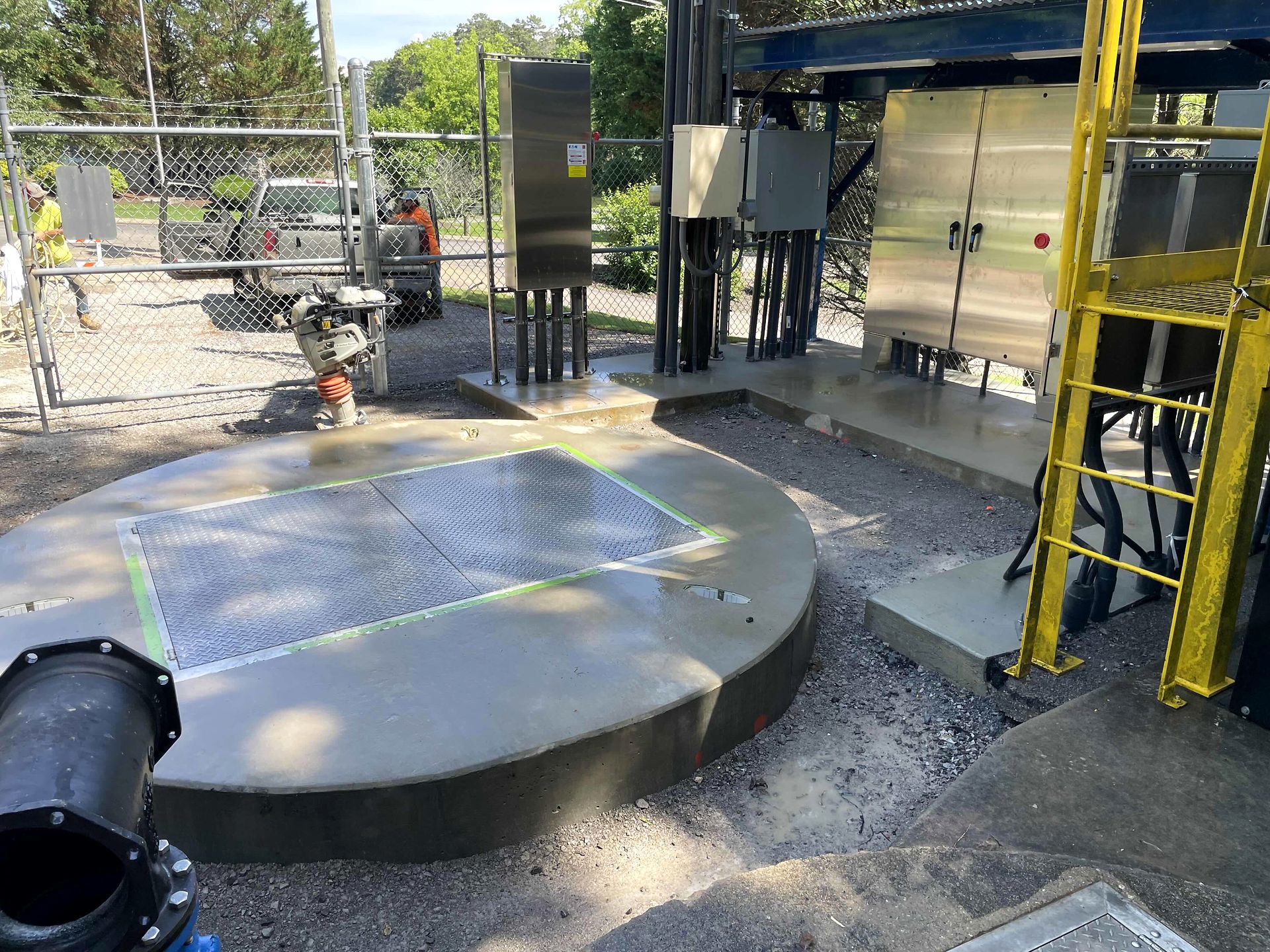 Pump station top slab with an access hatch beside stainless control panels in Blue Ridge, Georgia